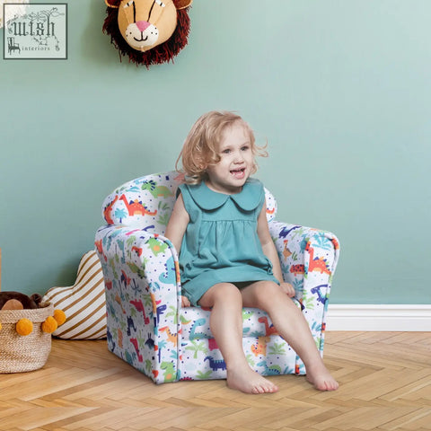 A child sits in a colorful kids armchair with cartoon dinosaur flannel-feel upholstery and sturdy wood frame
