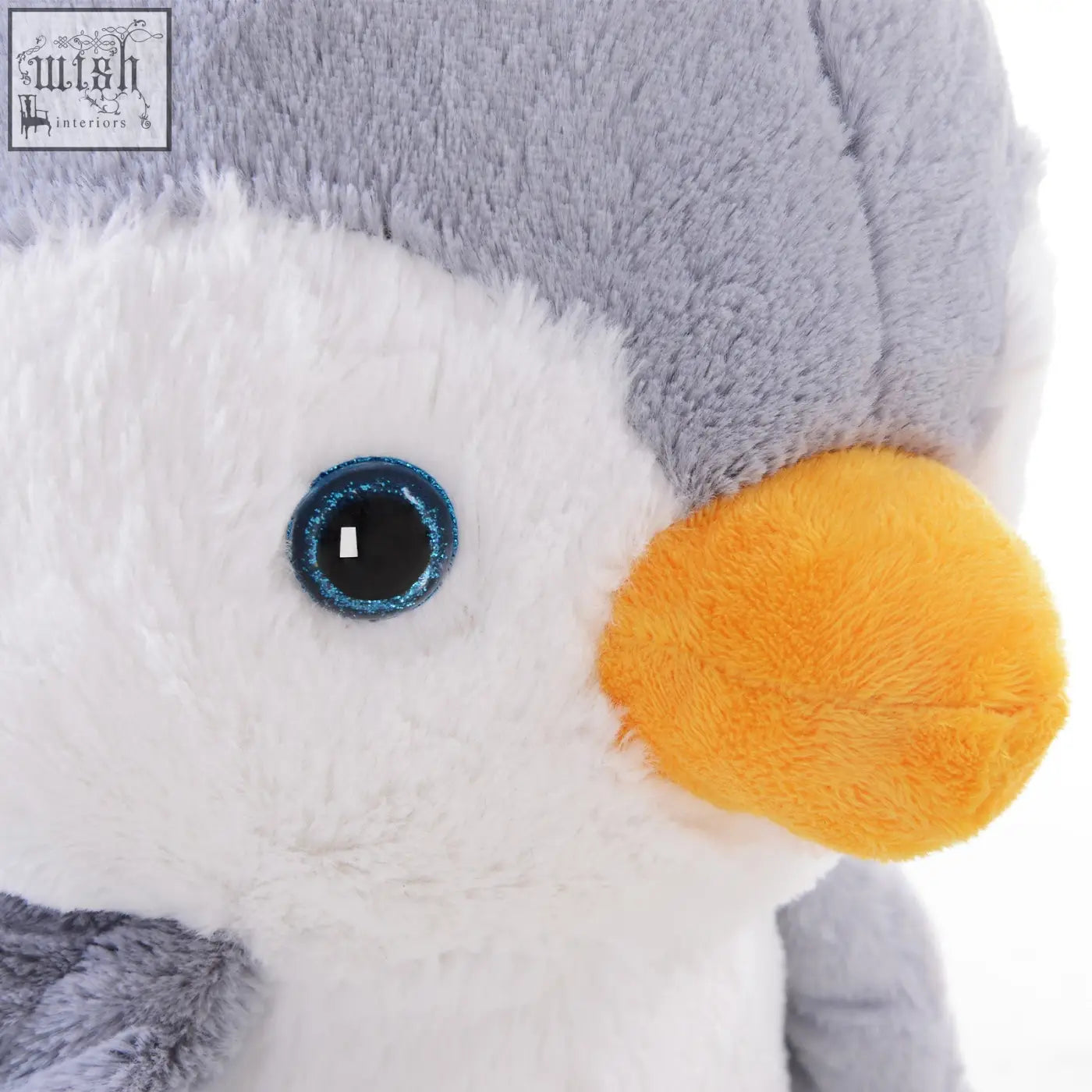 A plush penguin rocking horse with soft gray white fur bright orange beak sparkling blue eyes made with poplar wood and reinforced steel