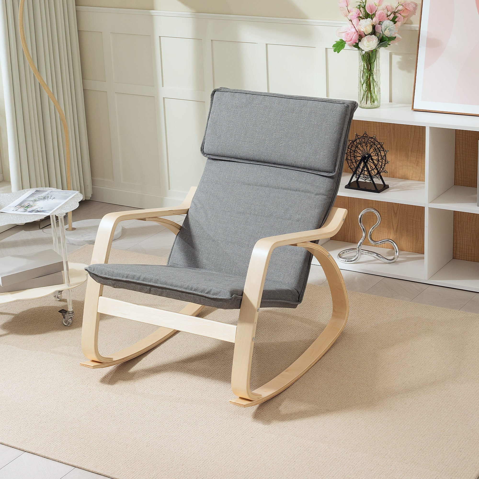 Gray upholstered rocking chair with breathable linen-feel fabric and light wood frame for living room relaxation