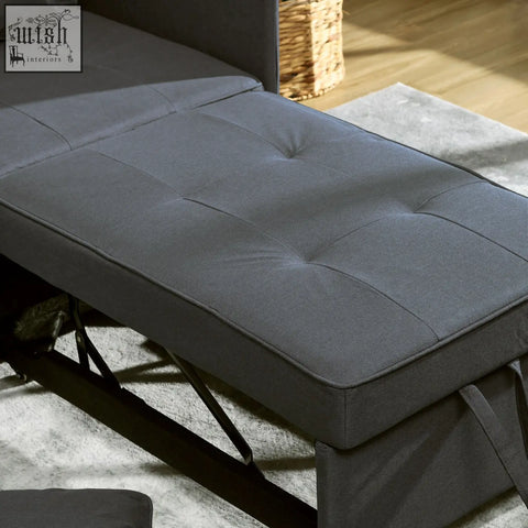 Dark gray tufted fabric ottoman with padded seat and sturdy black metal frame for comfortable chair bed in studio flats