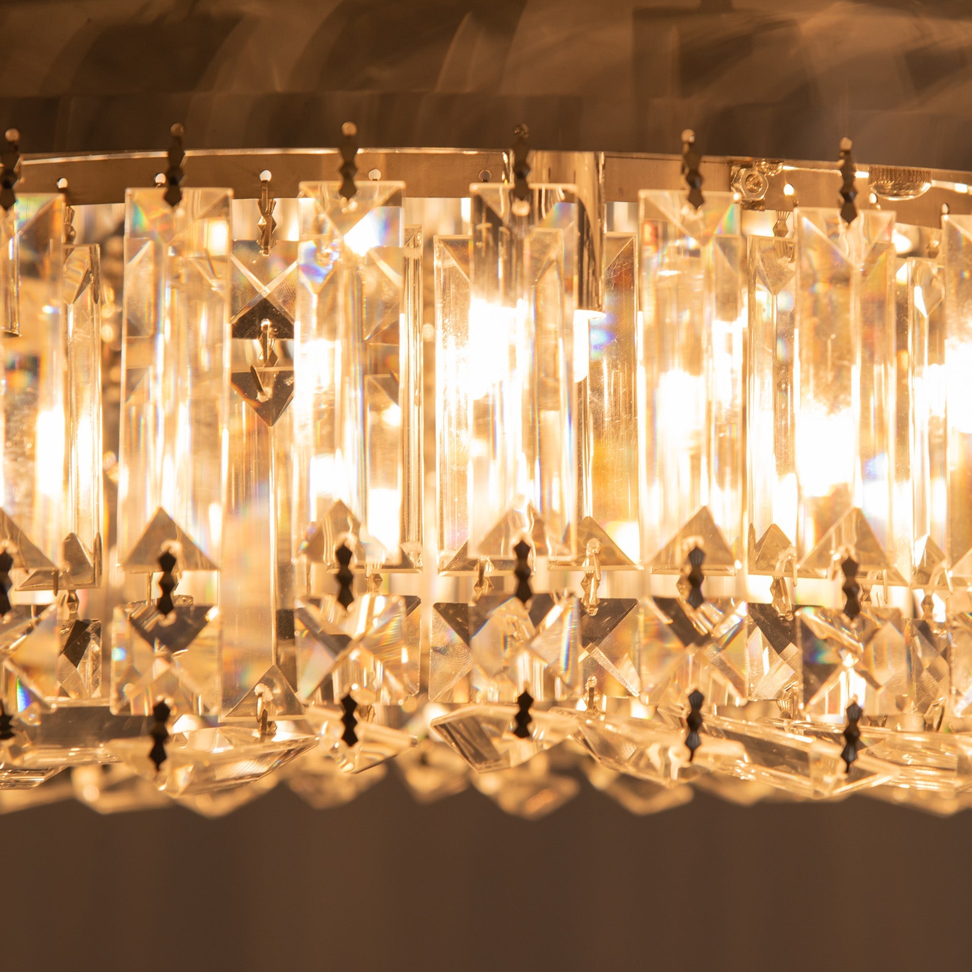 A modern crystal ceiling light with faceted glass beads and gold-toned metal accents for living room and bedroom