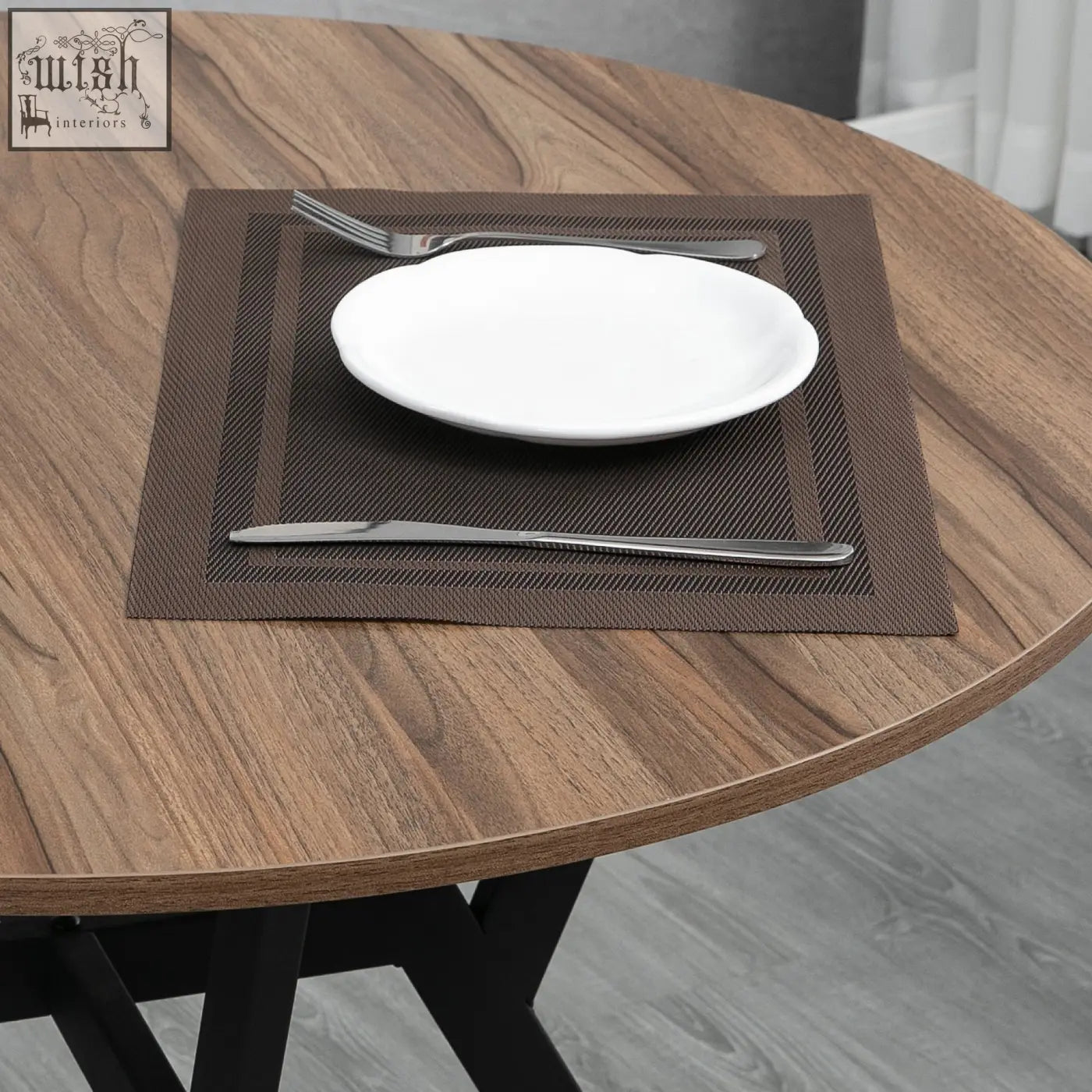 Brown textured placemat with white plate and silverware on homcom dining room table with black legs and foot pads