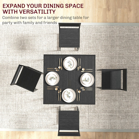 Black rectangular kitchen table with steel frame and mdf panels set with white leaf design plates and gold cutlery