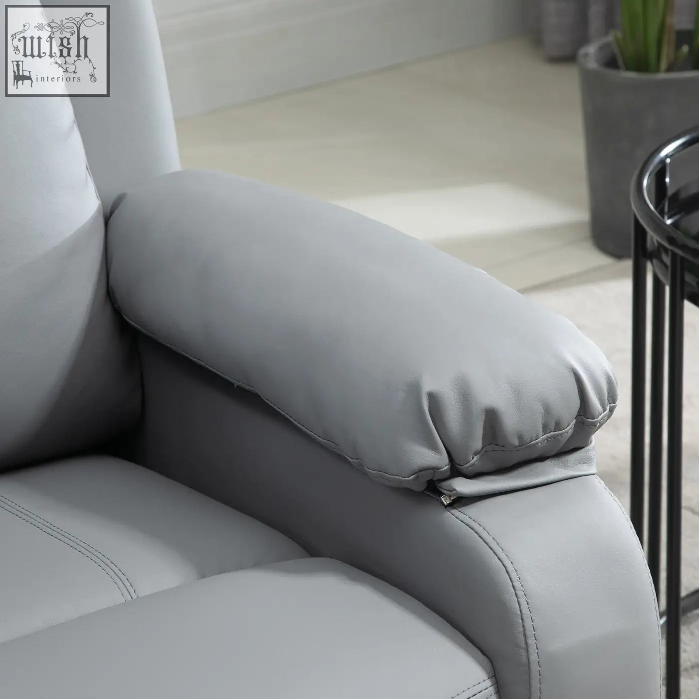 Gray leather armrest cushion with stitched seams on homcom electric power lift recliner chair with eight massage points and three intensity levels