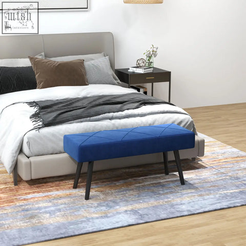 Vibrant blue tufted velvet end of bed bench with x shape design and powder coated steel legs for bedroom use