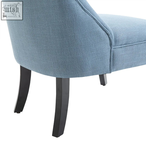 A light blue accent chair with linen-look fabric button tufting and sleek black curved solid wood legs for living rooms
