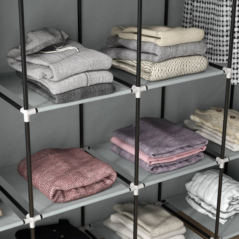 Black metal frame fabric wardrobe with ten compartments gray shelves and fabric drawers holding folded sweaters