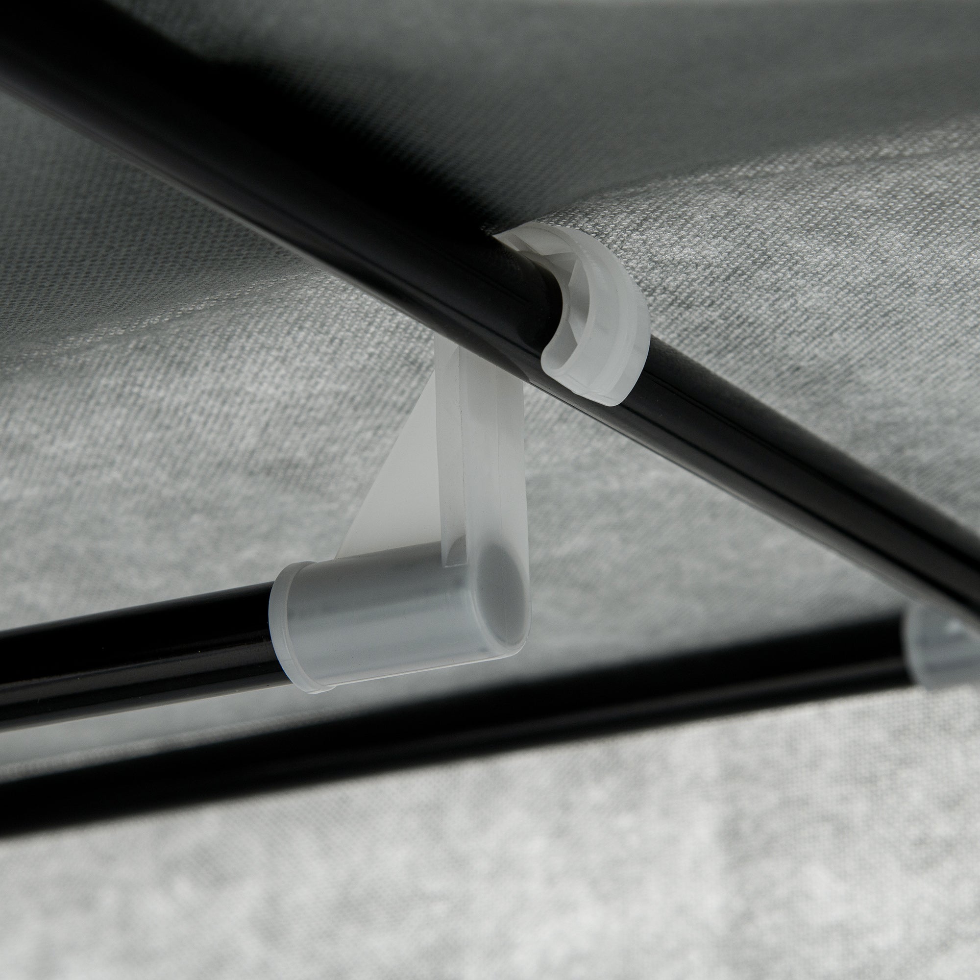 White plastic pipe clamp securing black metal frame of homcom dark grey fabric wardrobe with non-woven fabric cover and fabric drawers