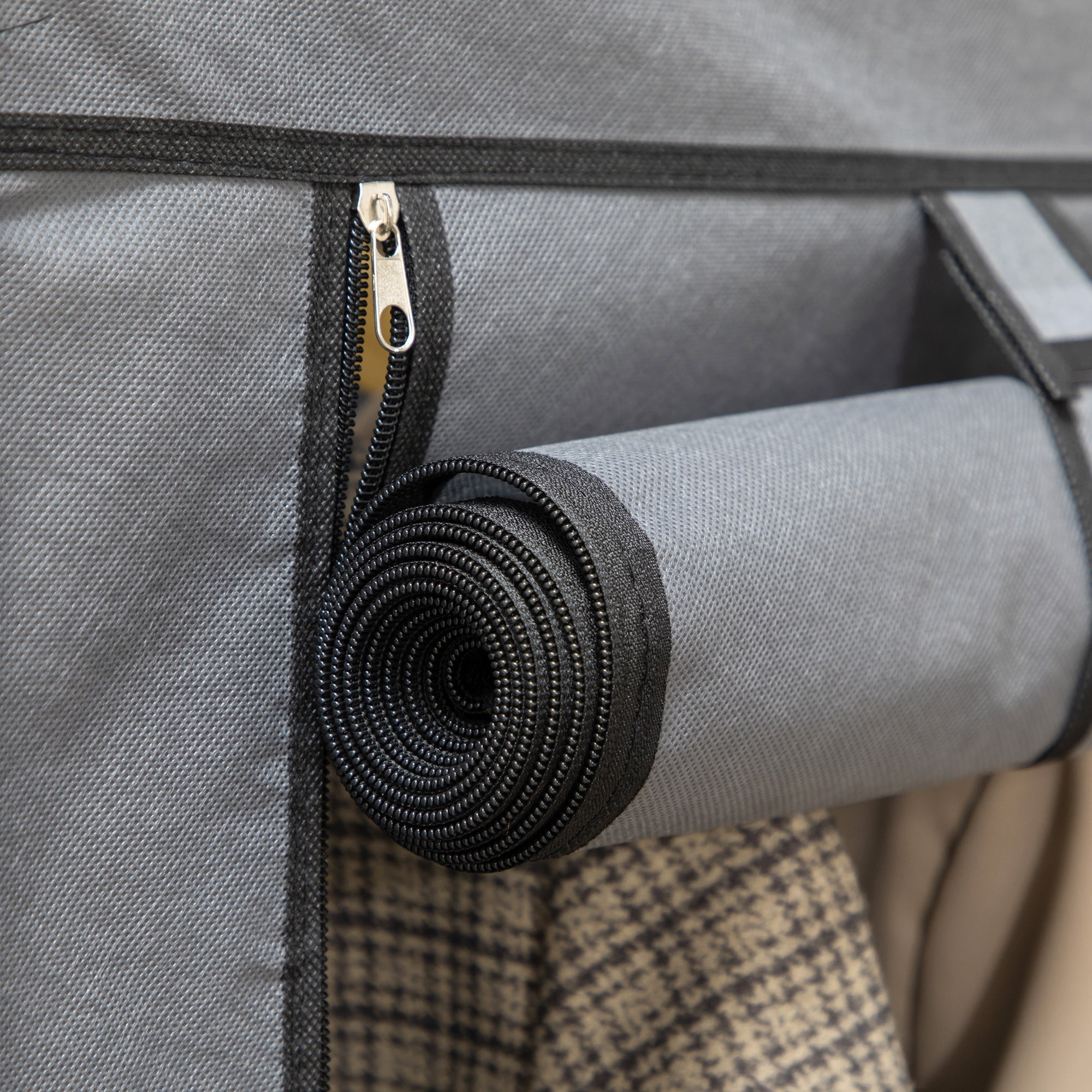 Black coiled elastic strap attached to dark grey homcom fabric wardrobe with non-woven fabric cover and hanging rod for clothes storage