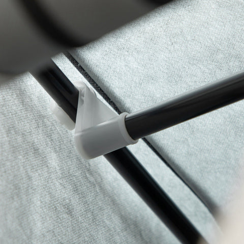 White plastic corner connector securing black metal frame to light grey non-woven fabric cover of homcom fabric wardrobe with hanging rod and clothes storage