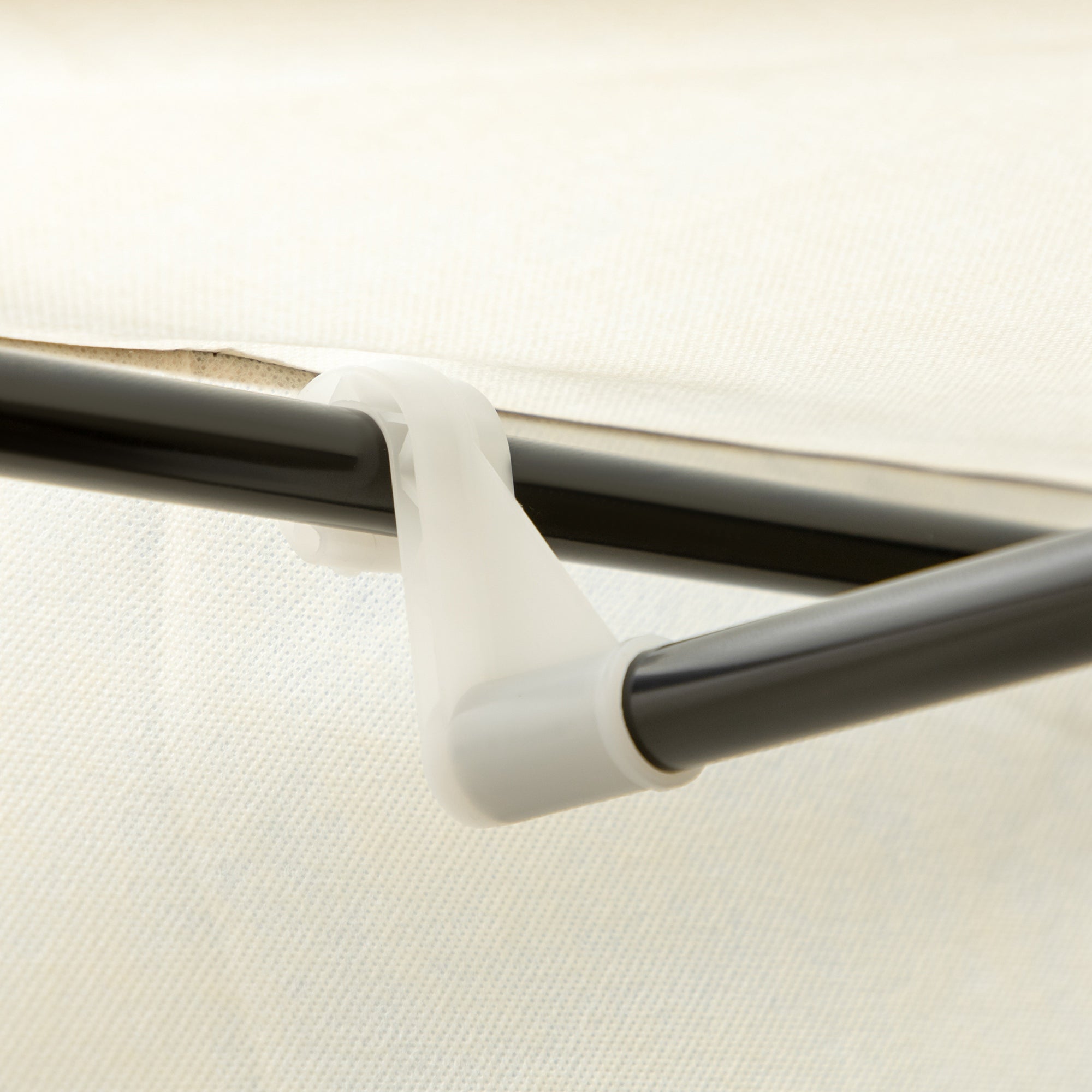White plastic shower curtain rod holder attached to the cream white homcom fabric wardrobe with coated steel frame and hanging rail