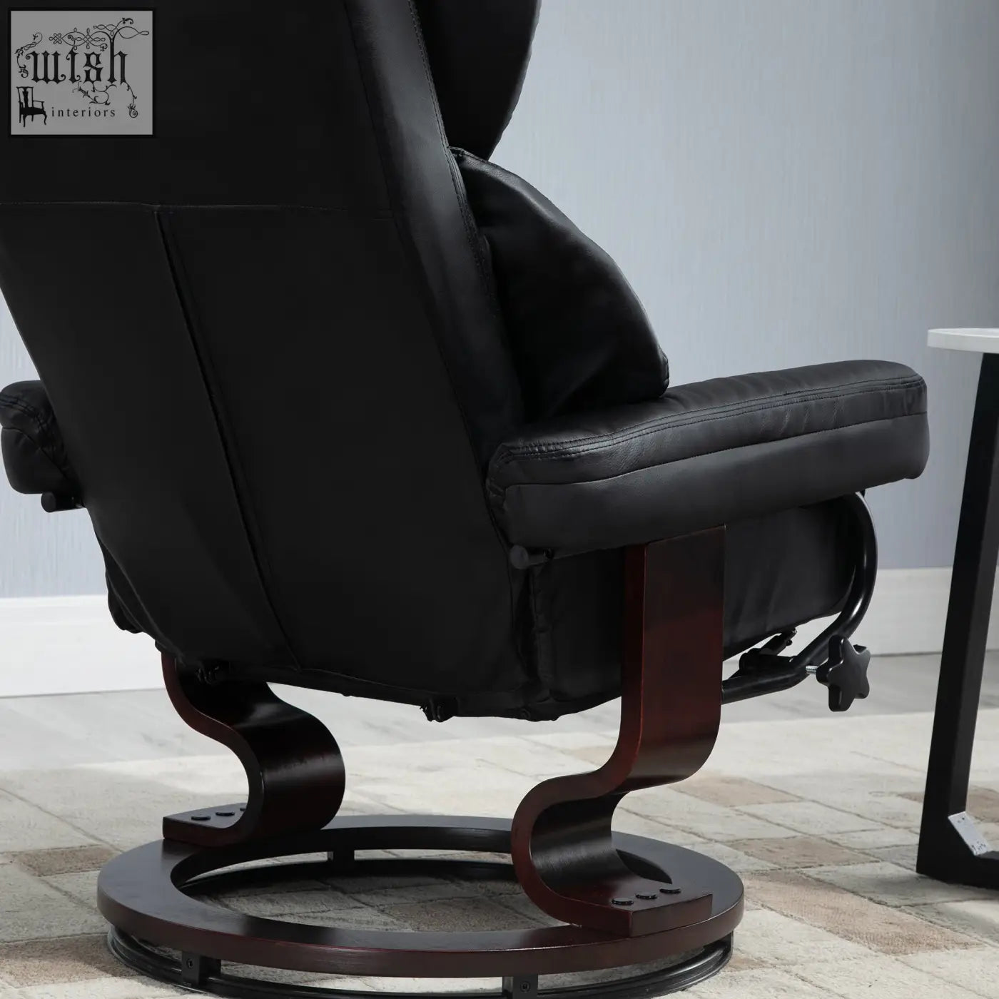 Black faux leather recliner chair with adjustable backrest and solid wood base on circular swivel platform