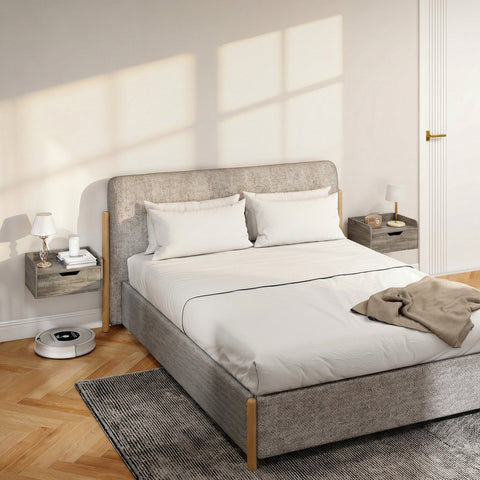 Gray upholstered bed with wooden legs and white bedding next to homcom floating nightstands in grey wood effect particle board