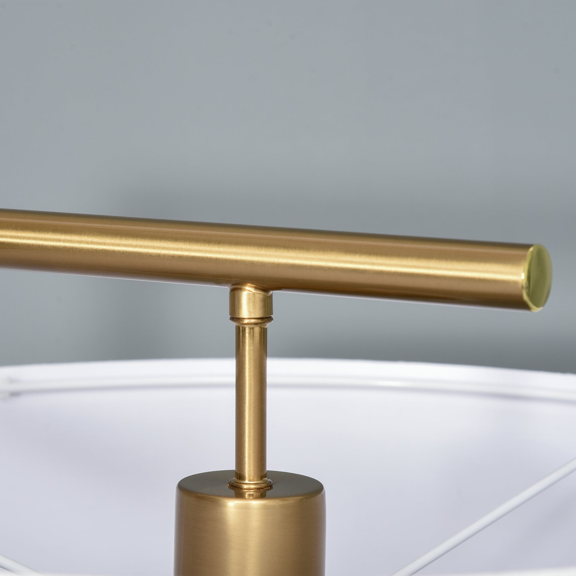 Gold-toned floor lamp with linen lampshade and cylindrical base perfect for living room or bedroom lighting
