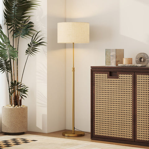 A tall slender homcom floor lamp in gold tone with an off-white linen shade and adjustable dimmable light colors