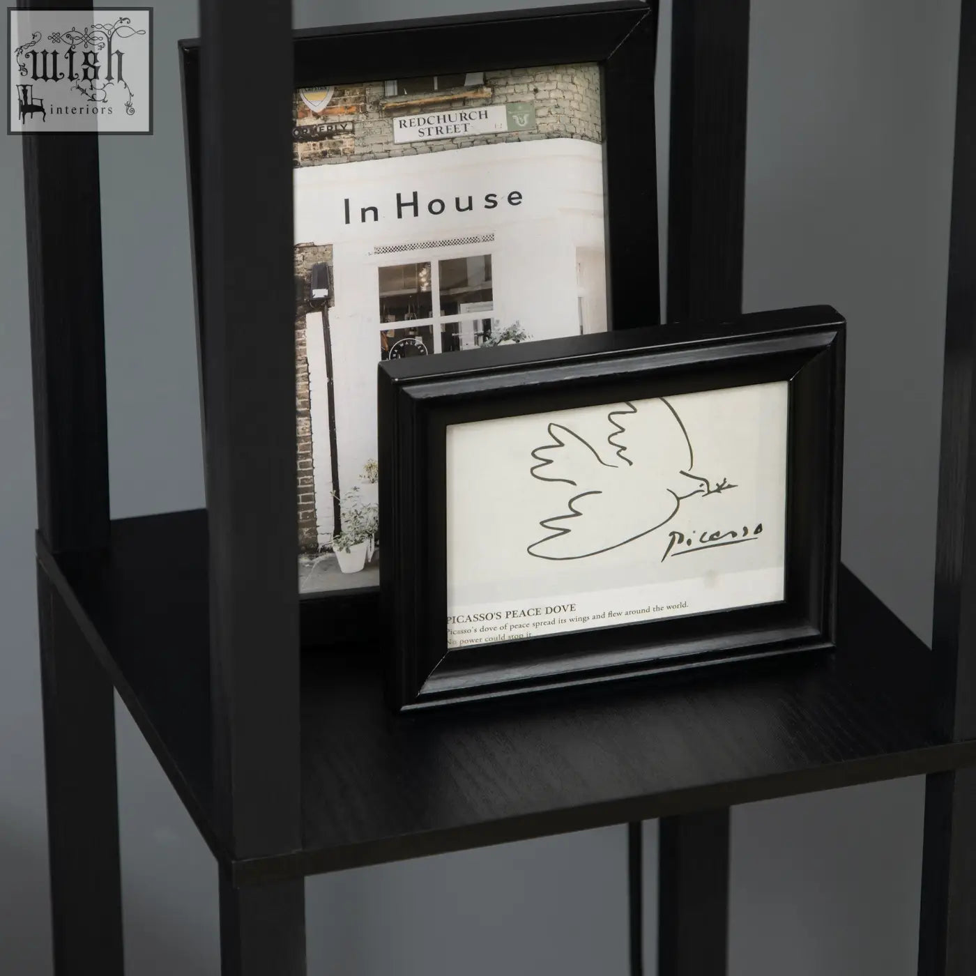 Black framed minimalist line drawing of a dove with picasso signature shown with homcom floor lamp with two shelves and chain switch