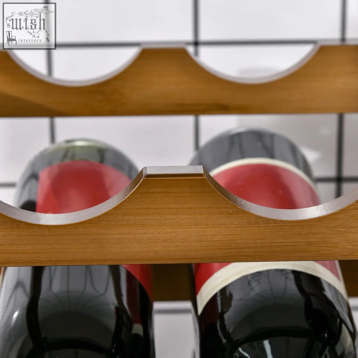 Light brown bamboo wine rack with silver metal accents holding red wine bottles for home bar wine storage rack