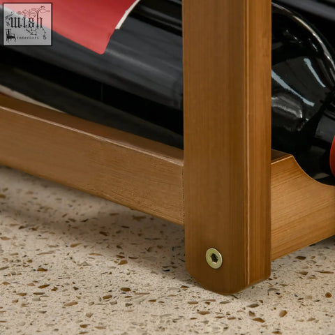 Light brown bamboo wine rack with 16 bottle holders and a visible brass screw at its base for wine storage rack