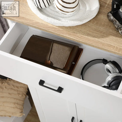 Brown leather wallet with visible stitching and wooden accent placed on the open countertop of a white particle board kitchen cupboard