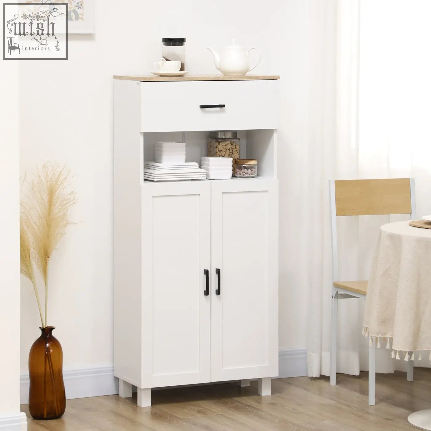 White freestanding kitchen cupboard with particle board open countertop and black handles featuring anti-tipping straps