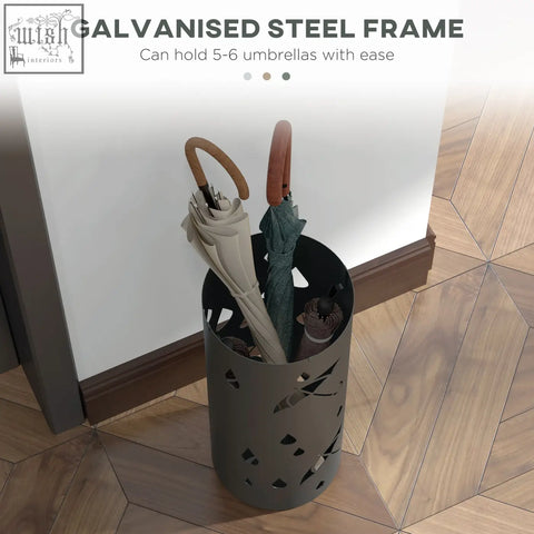 A sleek dark grey galvanised steel umbrella stand with modern cut-out design drip tray and hooks for entryway use