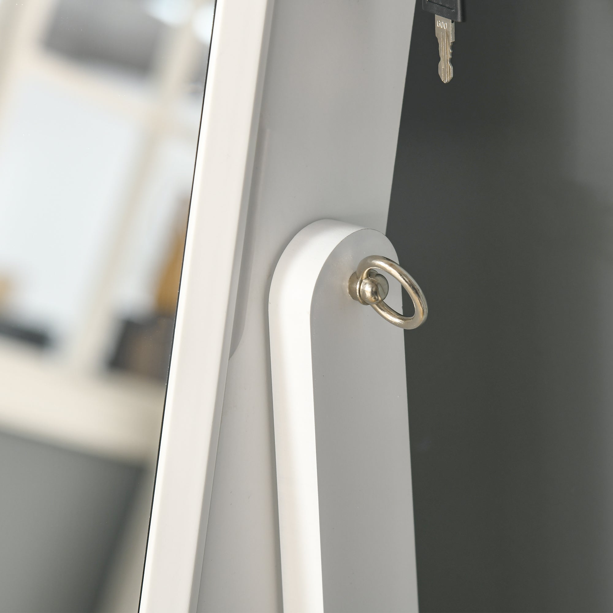 White framed full length mirror with silver metal ring featuring earring slots and ring slots for bedroom storage