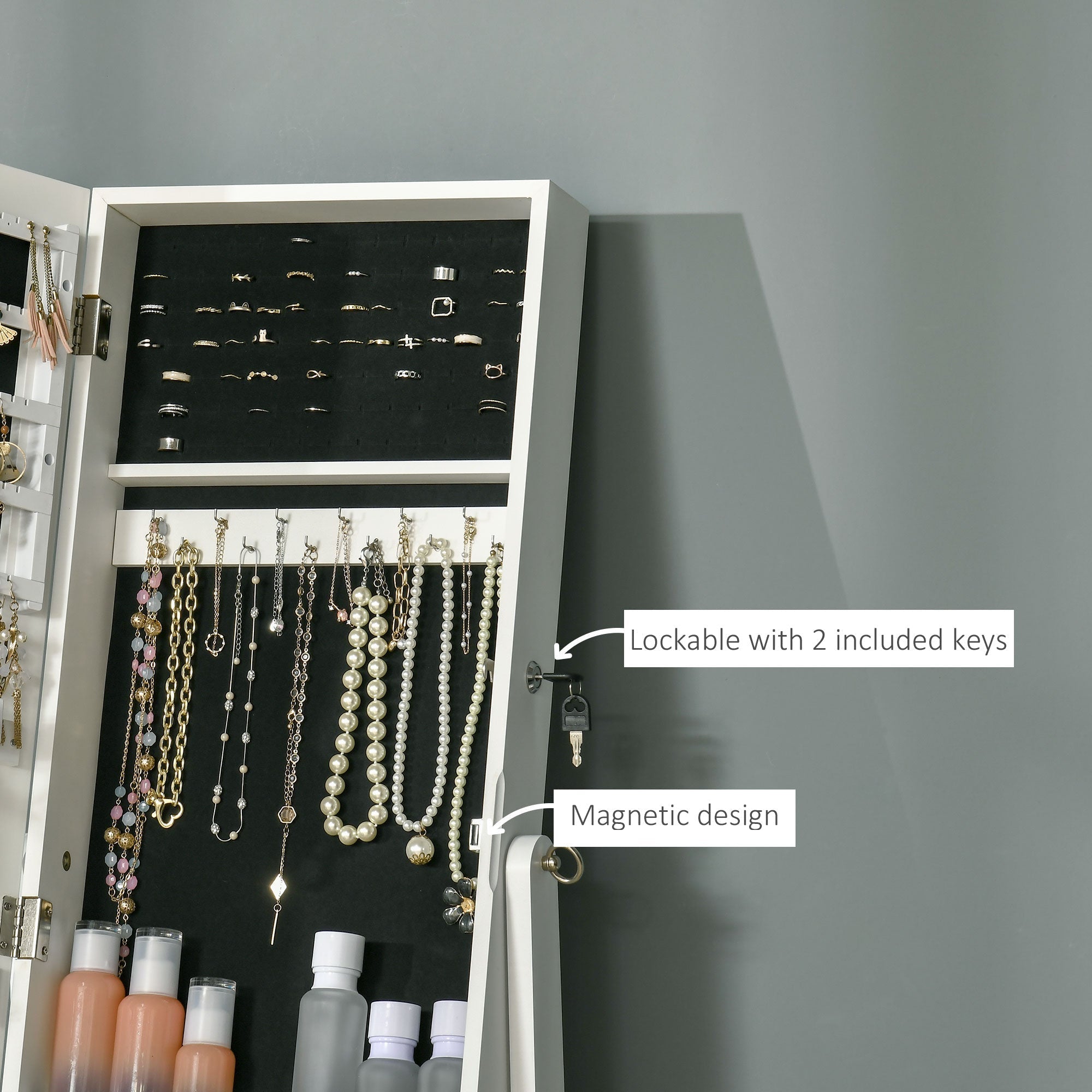 White magnetic jewelry armoire with black interior and silver hardware features earring slots ring slots and length mirror