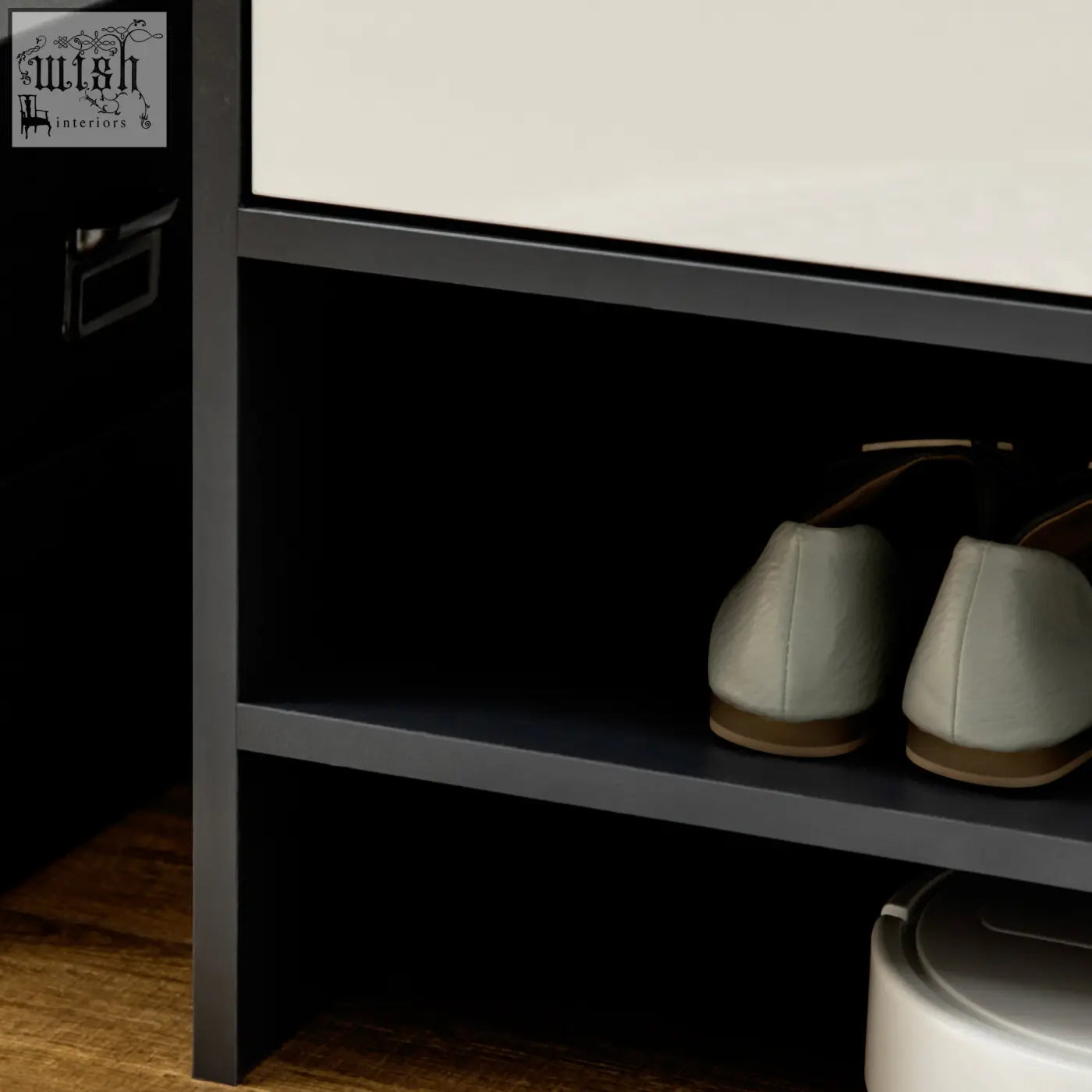 A pair of light gray suede loafers on a dark gray shelf inside a homcom high gloss shoe cabinet with white doors