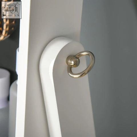 Gold-toned metal ring on white homcom jewellery cabinet with led light earring slots and necklace hooks for bedroom use