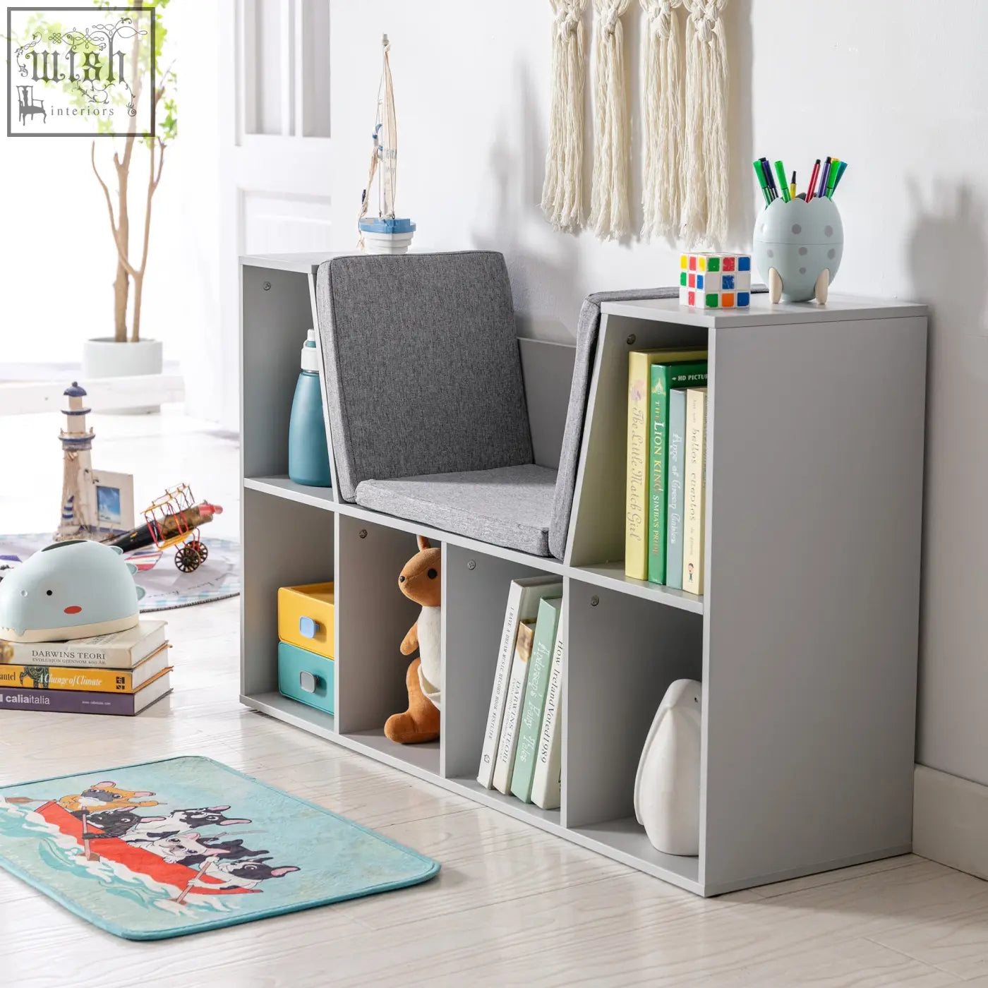 Gray fabric-upholstered chair built into a grey kids bookcase with six compartments and wear-resistant melamine veneer