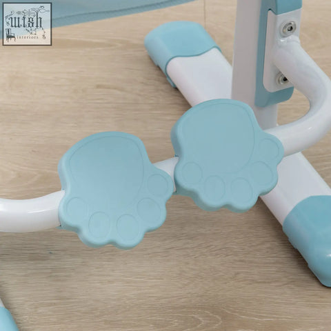 Light blue paw-shaped plastic footrests attached to white metal frame of homcom kids desk and chair set with curved backrest