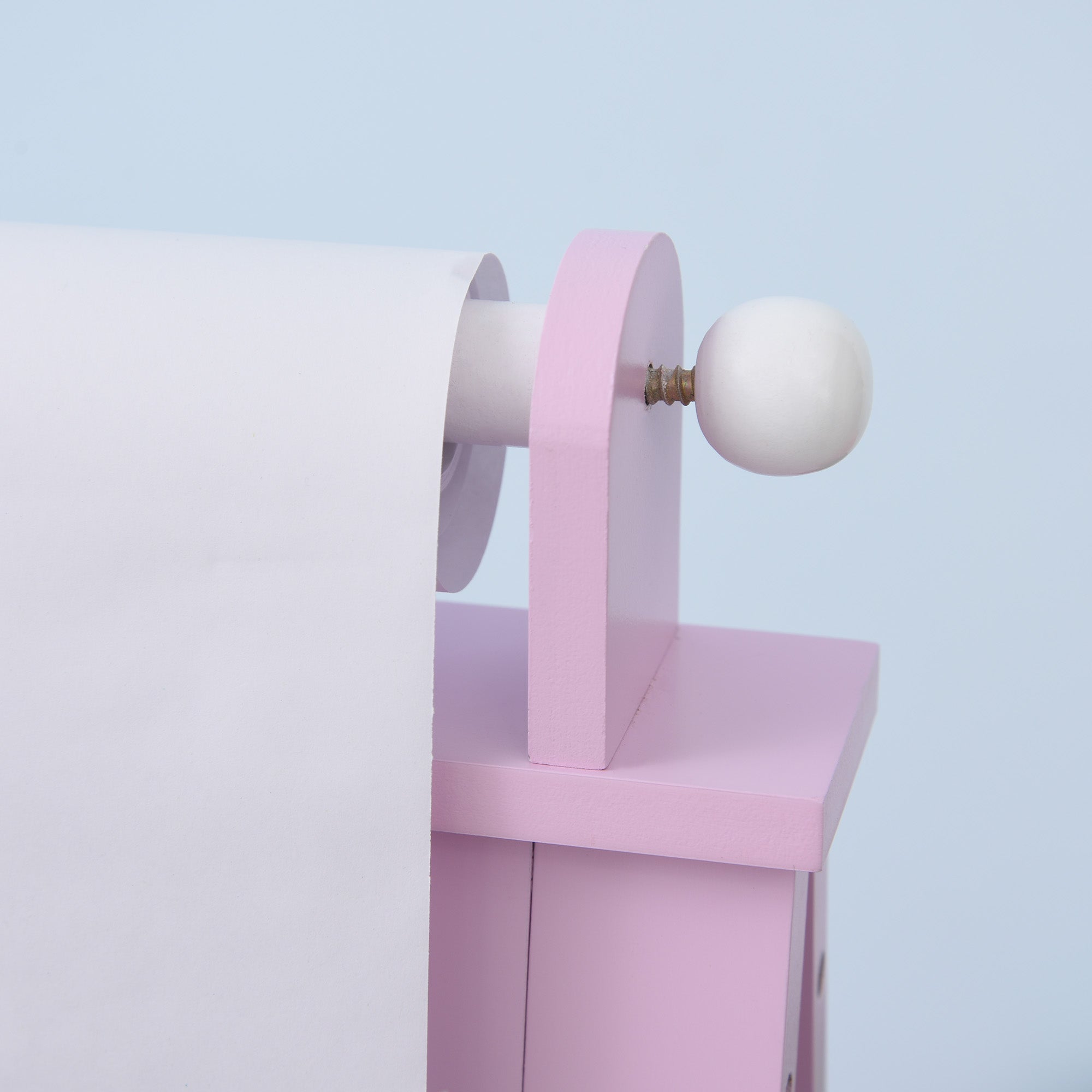 Pink wooden curtain rod with white spherical finial on homcom kids easel with paper roll and storage baskets