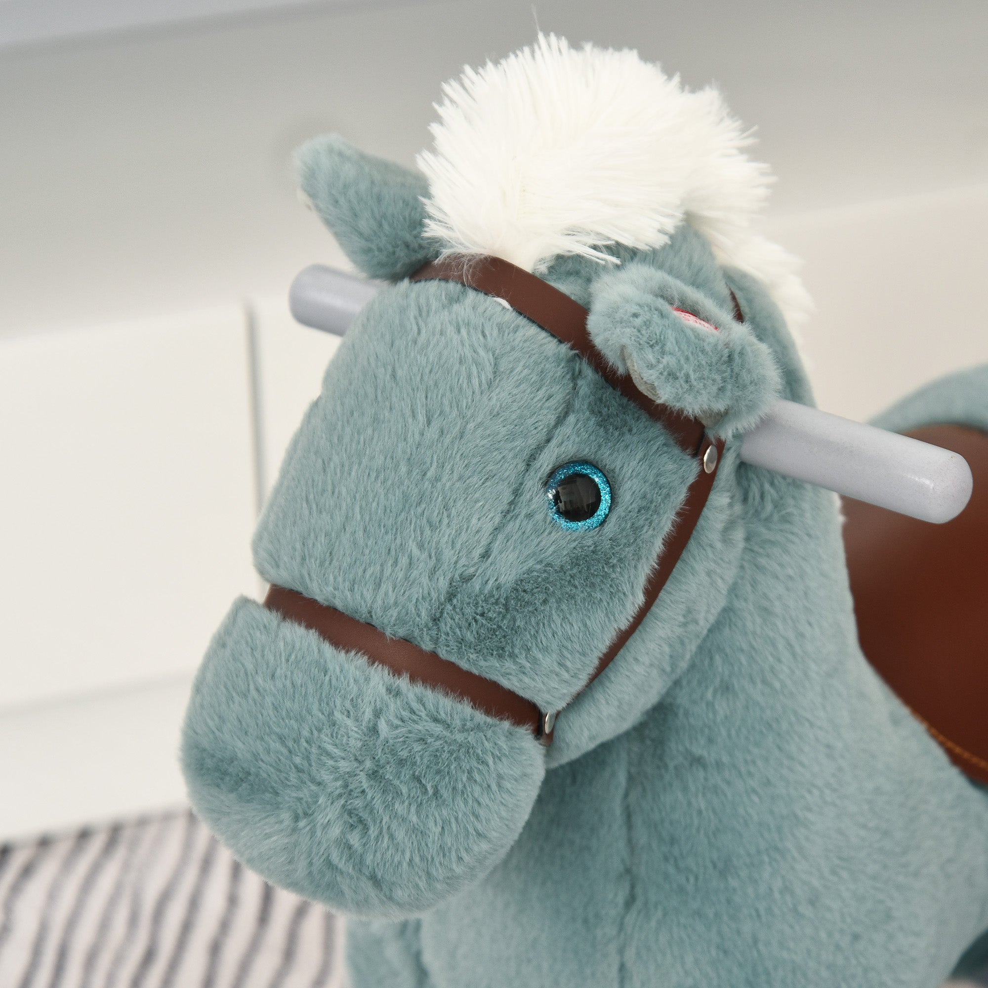 Homcom kids plush teal rocking horse with white mane and brown bridle lets toddlers sit comfortably and enjoy realistic sounds