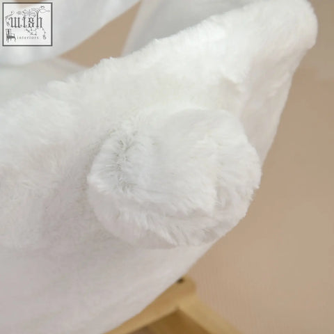 A white plush fuzzy hat on the homcom kids rabbit-shaped rocking horse with safety belt and realistic sounds
