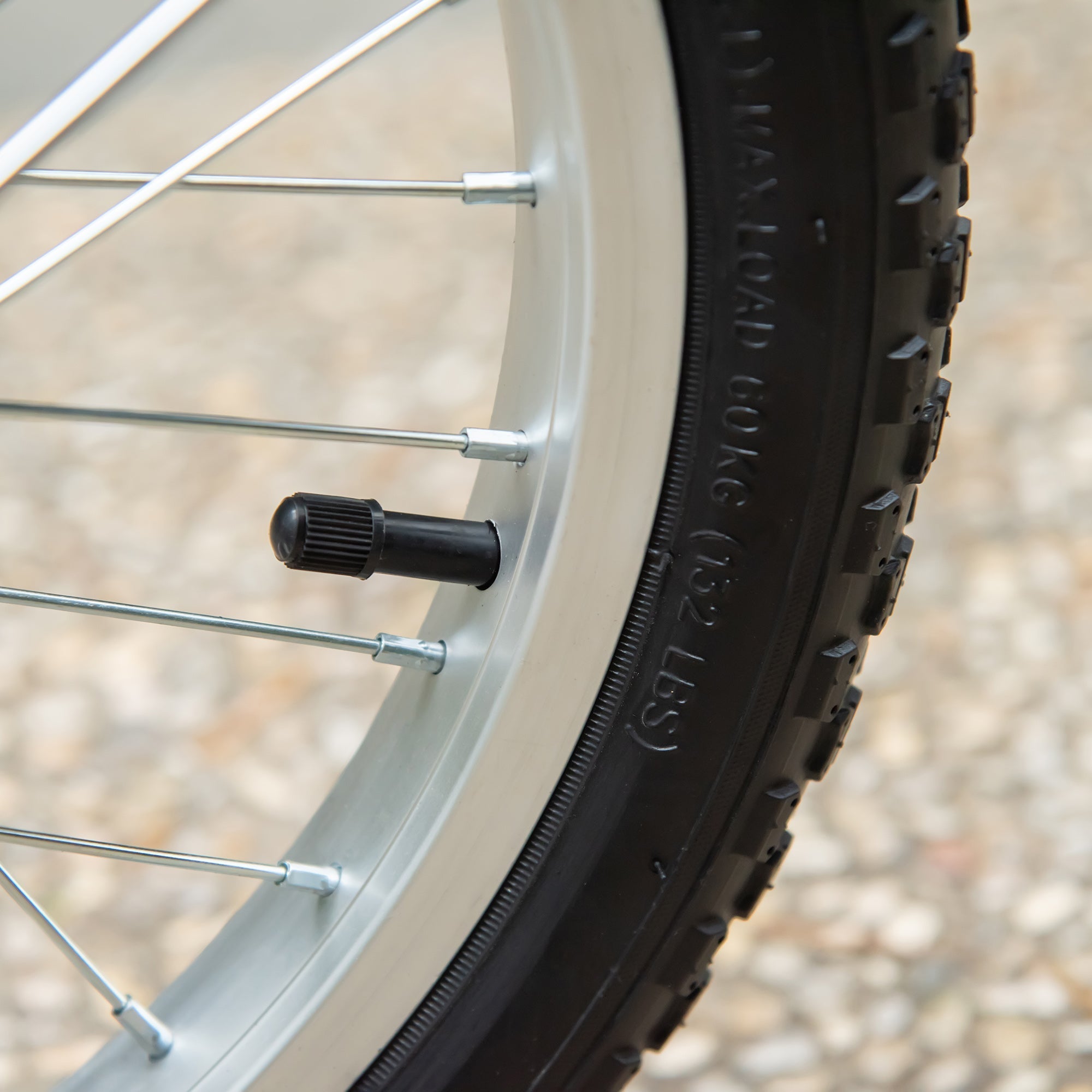 Black rubber tire valve cap with textured grip on pink homcom kids scooter wheel with adjustable handlebar and dual braking