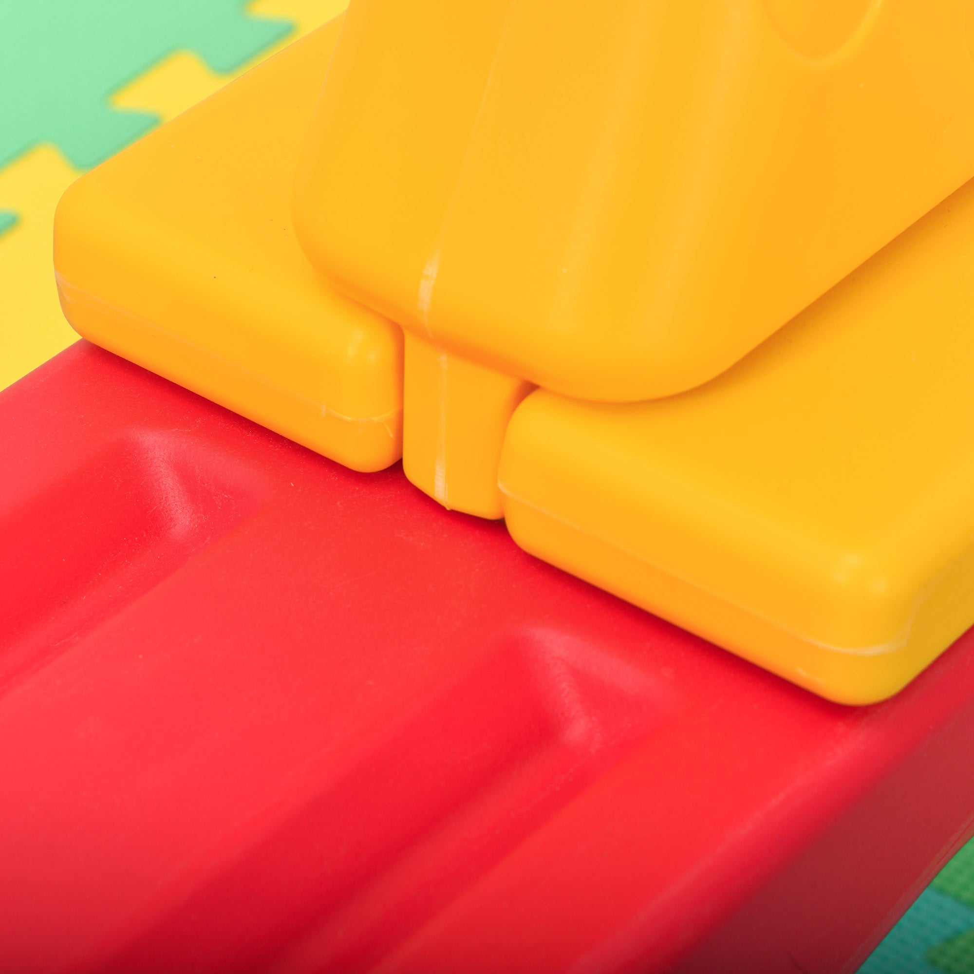 Bright yellow plastic building blocks with smooth edges featured with homcom kids seesaw colorful animal design safe for toddlers