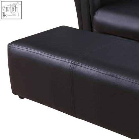 Black faux leather kids twin sofa with stitched seams rounded edges and matching footstool has sturdy weight capacity