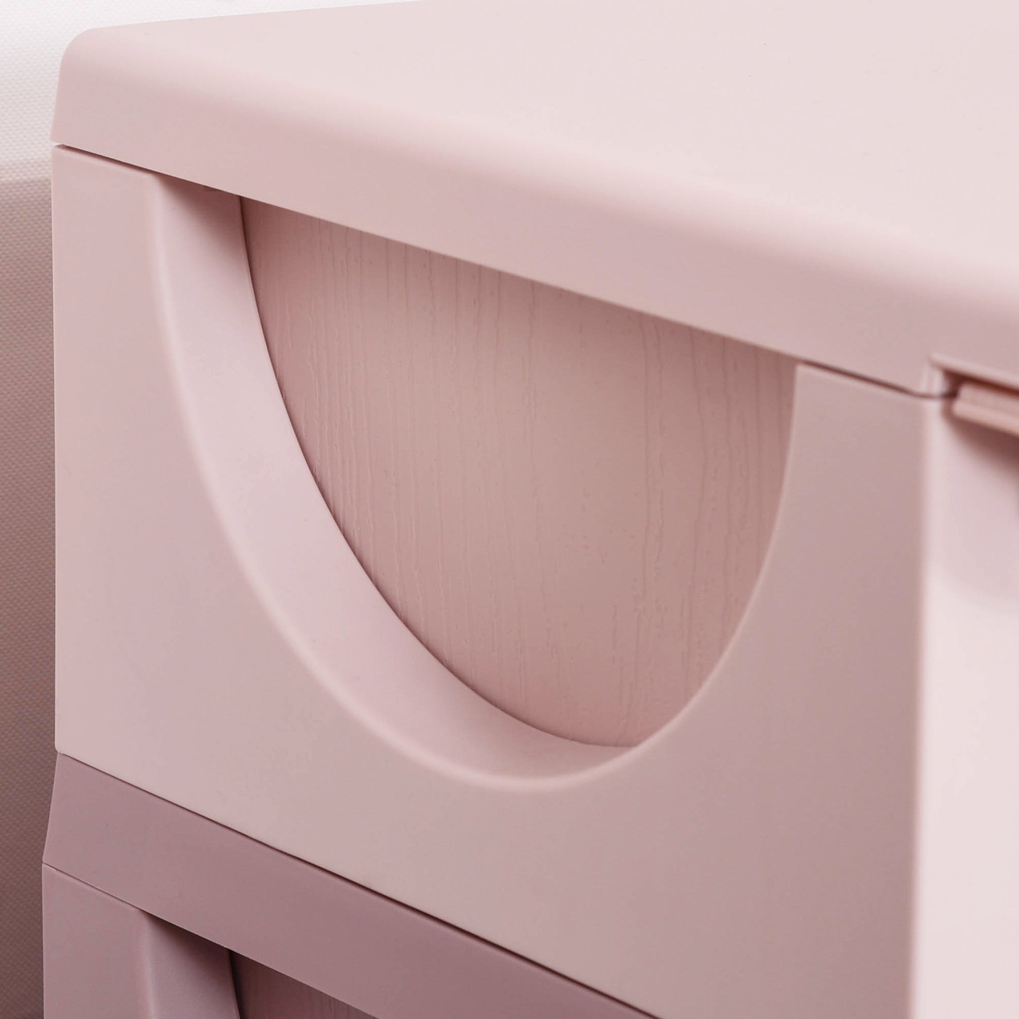Pastel pink plastic kids storage box with three drawers and stump feet for nursery and playroom organization