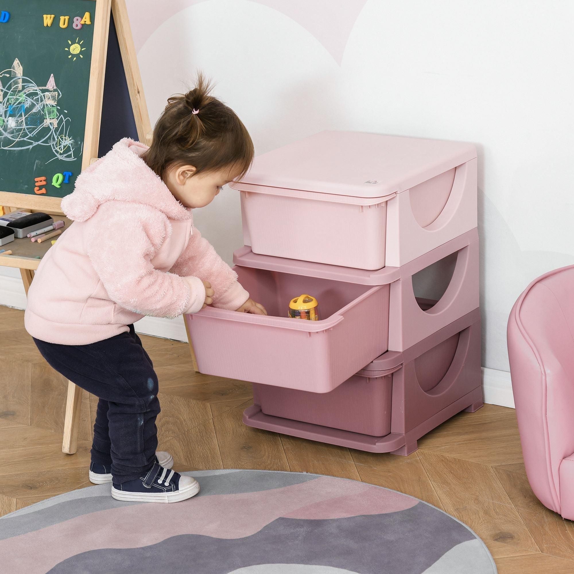 Stacked pink plastic kids storage unit with three drawers rounded handles stump feet and matching lid for nursery organization