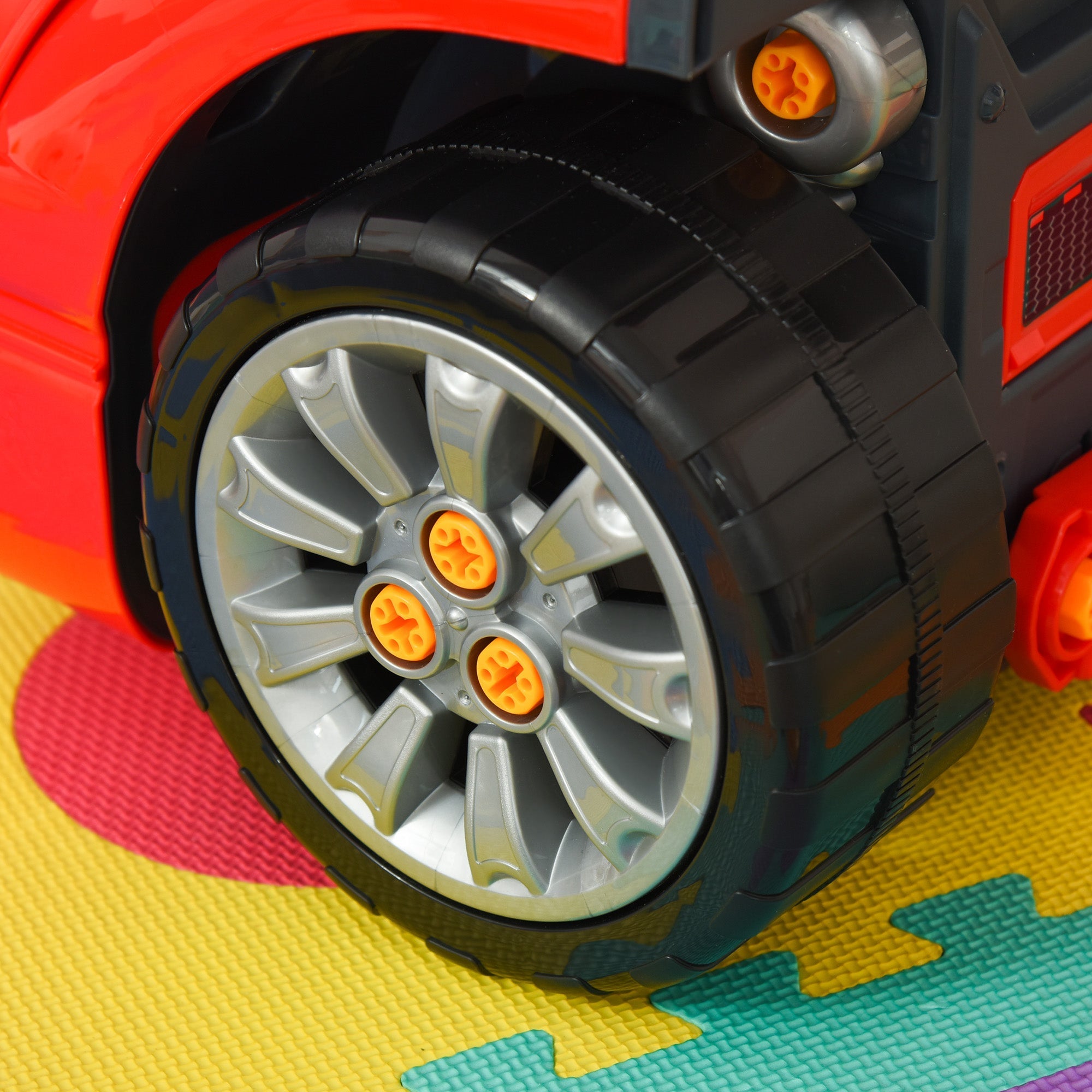 Red kids ride-on car with silver alloy rims and orange star caps from homcom engine toy set with car key and horn