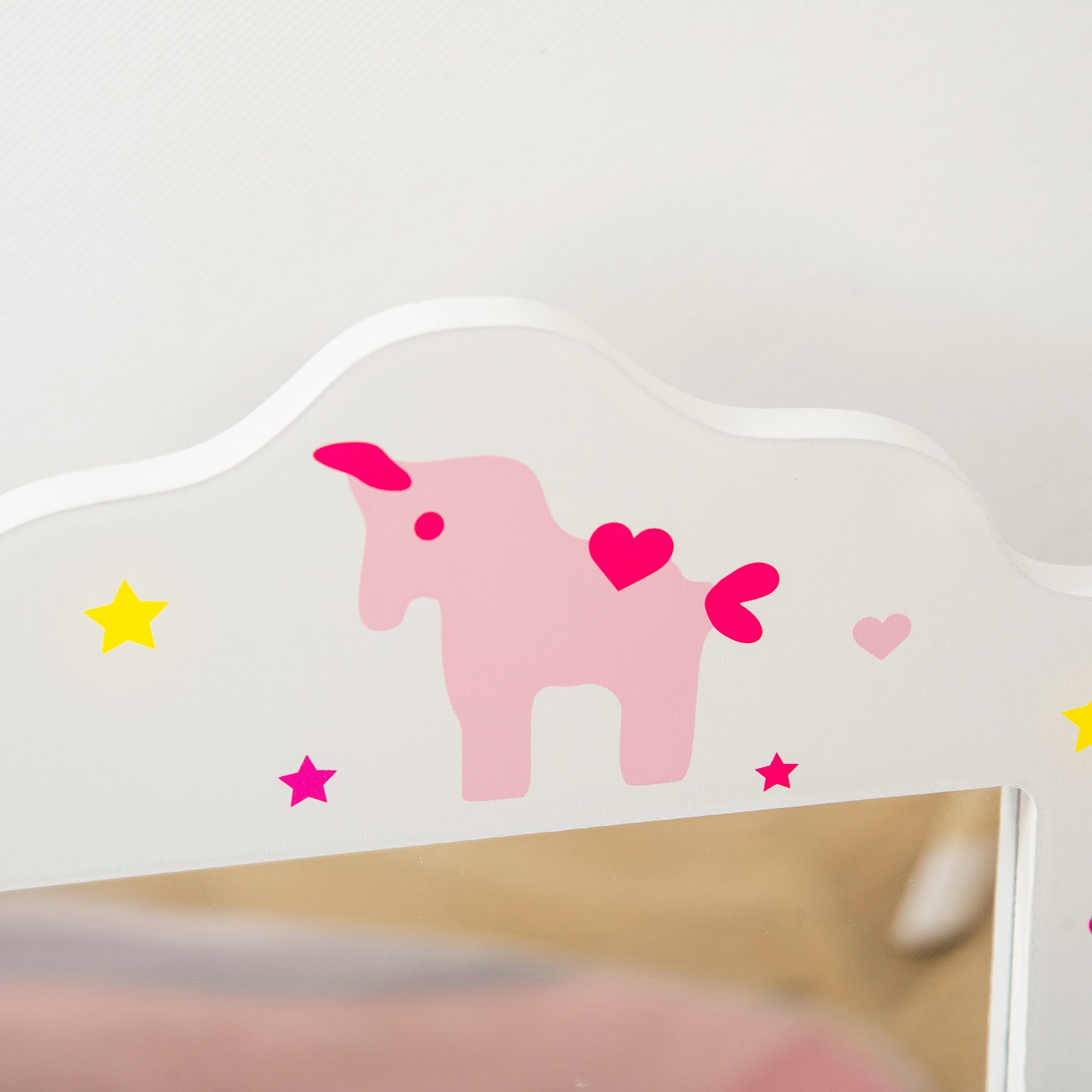 White wooden kids vanity table headboard with pink unicorn decal hearts and yellow magenta star accents