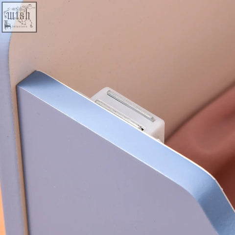 Silver metallic bookend with white plastic base and slots next to blue homcom kids storage box bench organizer