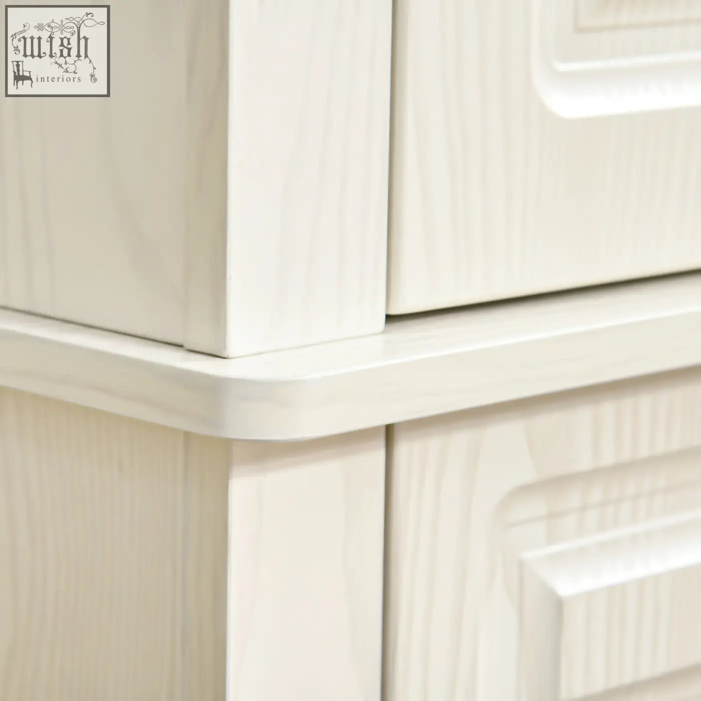 Cream-colored wooden dresser with subtle grain finish and raised panel drawers in white wood grain design
