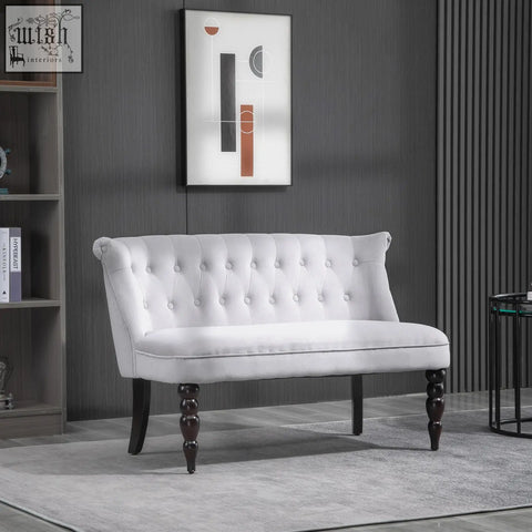 White tufted velvet-feel loveseat with carved legs and scrolled ends for compact bedroom or living room use