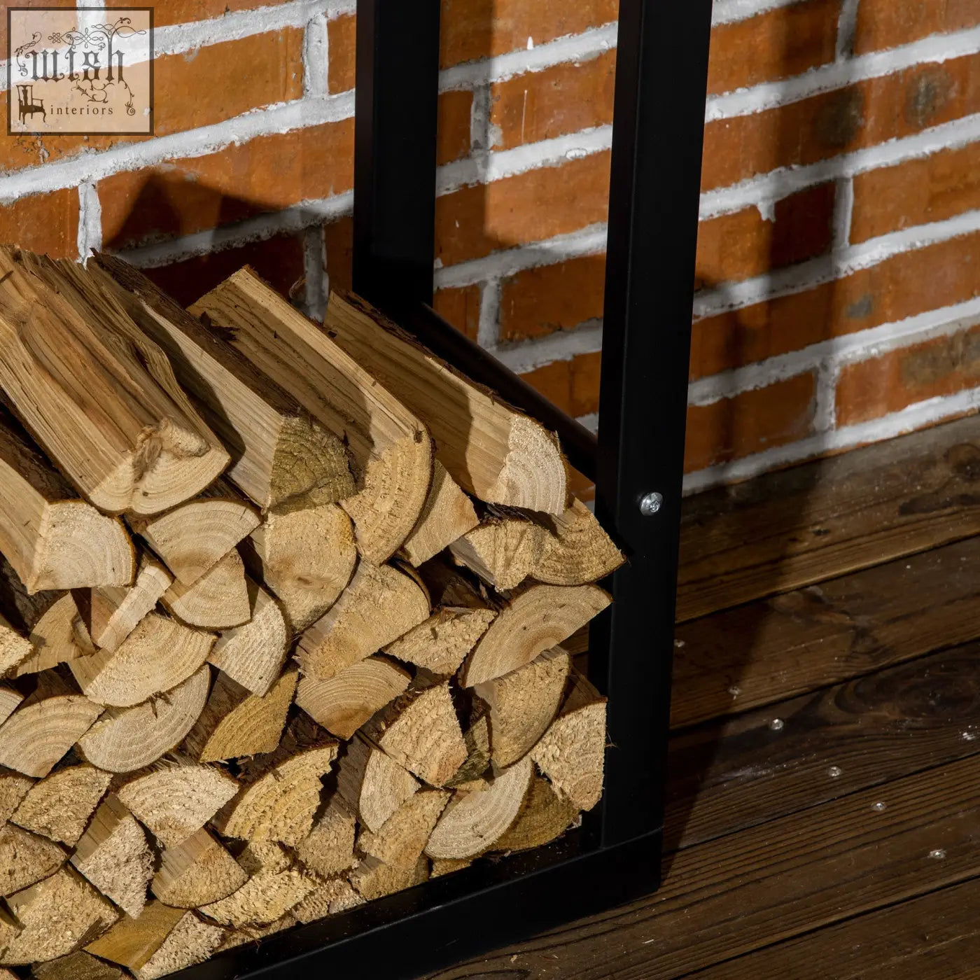 Black metal firewood rack log holder with design allows neat wood storage of light brown split logs indoors outdoors