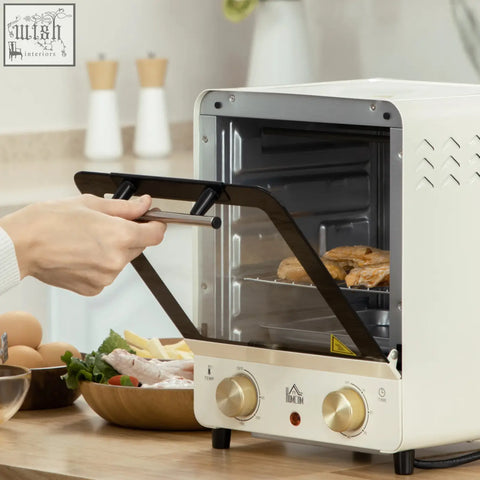 Cream white homcom mini oven with black glass door, gold knobs, crumb tray, baking tray, and 15 litre capacity