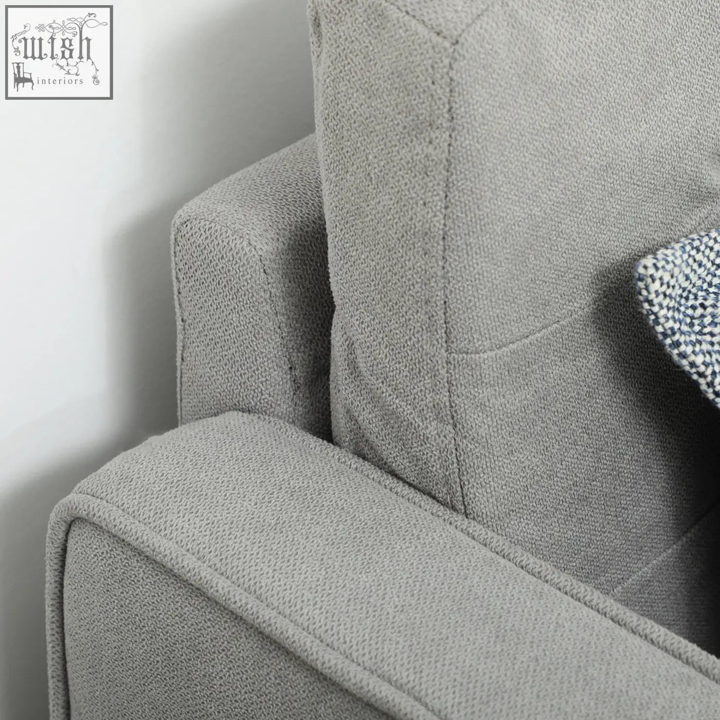 Gray textured fabric armrest of a homcom light grey tufted cotton couch with wood legs ensure sturdy support