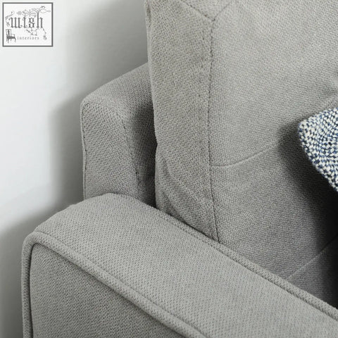 Gray textured fabric armrest of a homcom light grey tufted cotton couch with wood legs ensure sturdy support