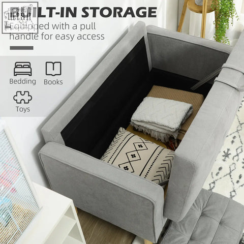 Gray upholstered storage ottoman with black interior and pull handle complements light grey tufted cotton couch with wood legs ensure stability