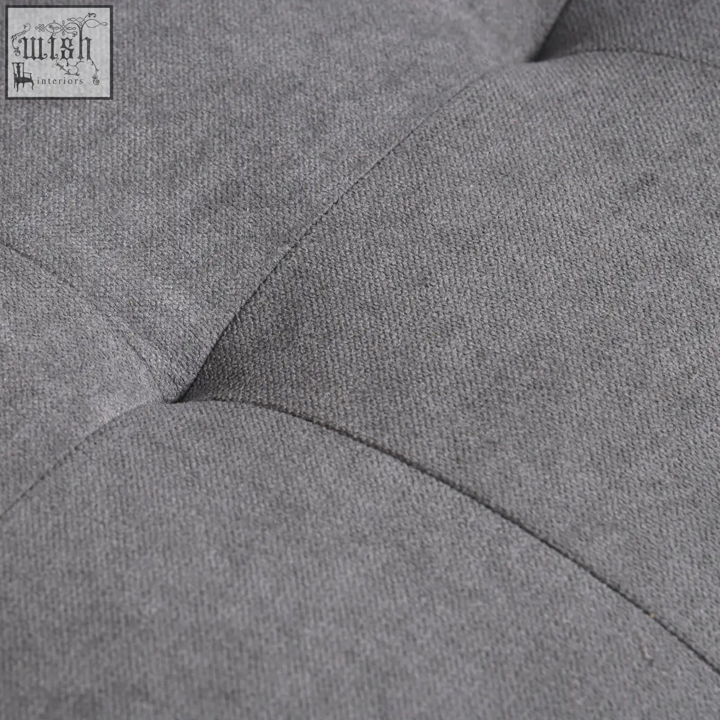 Gray tufted fabric seater sofa with stitched button details and eucalyptus wood legs ensure hidden storage comfort